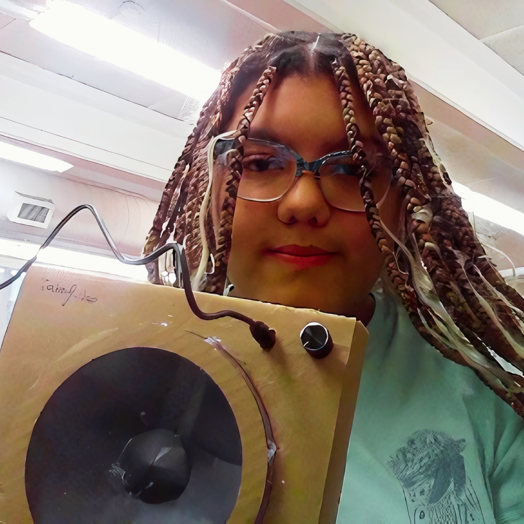 Student holding completed speaker build
