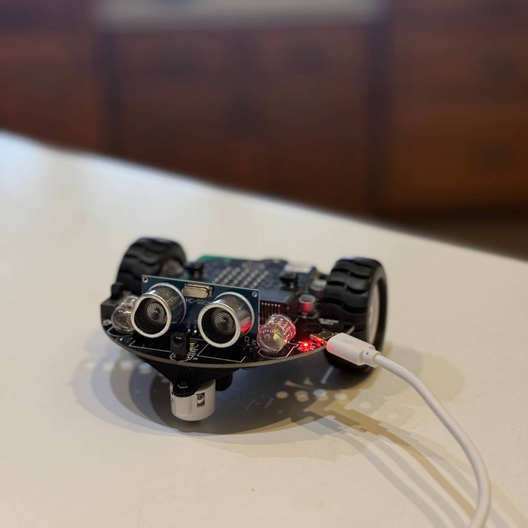 Kids assemble an autonomous vehicle from a STEM kit, exploring robotics and engineering skills.