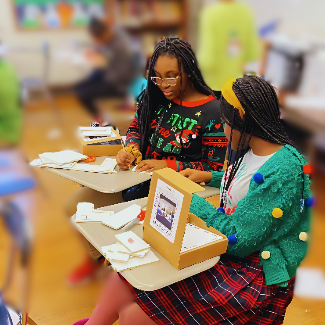 Kids build a model building from a STEM project to explore temperature and humidity control.