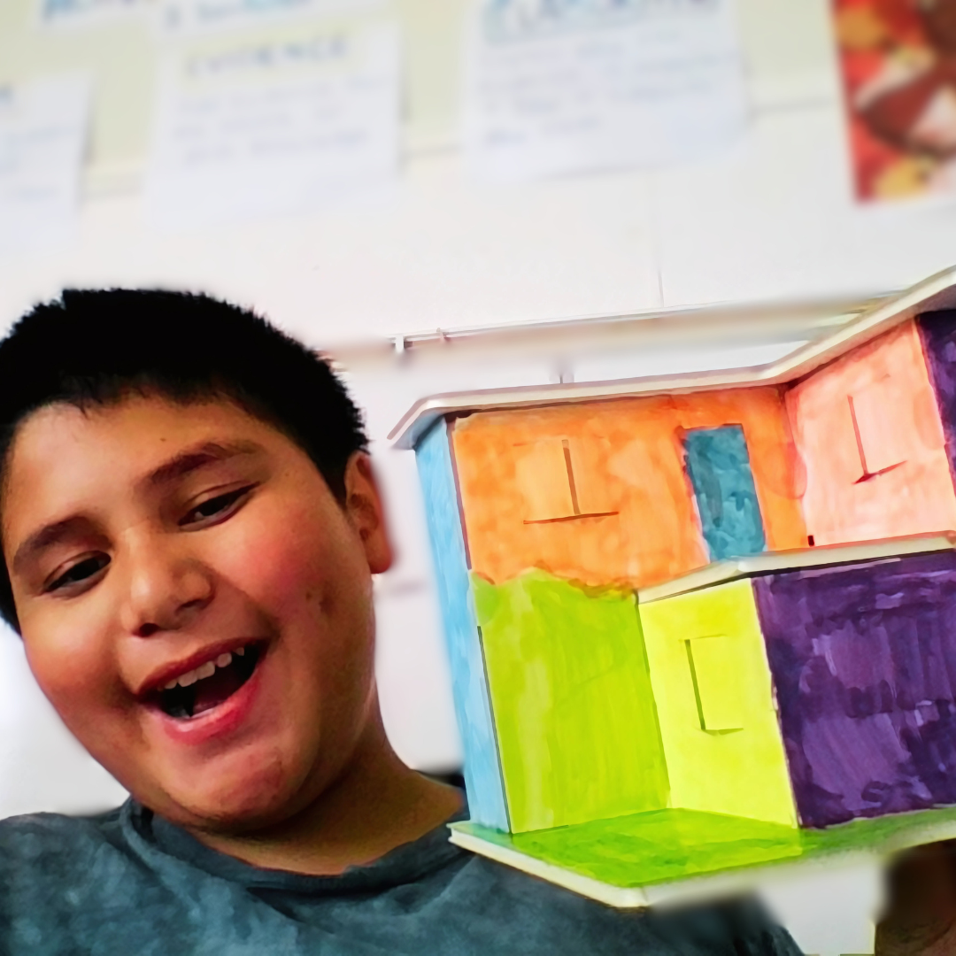 Kids build a model building from a STEM project to explore temperature and humidity control.