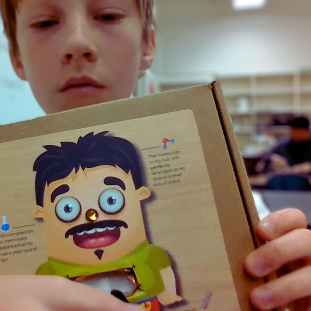 Kids assembling a circuitry game from a STEM project, exploring electrical engineering concepts.