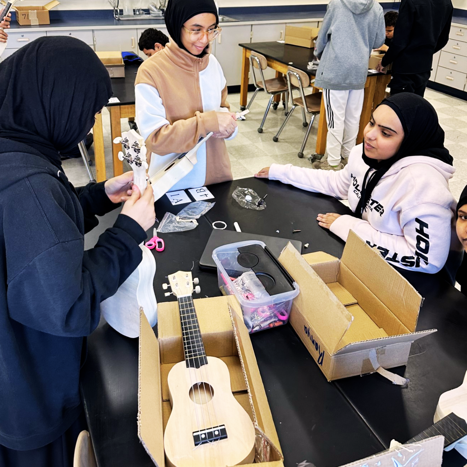Middle school students engaging with Compass STEM curriculum activities that connect science and technology to real-world applications.