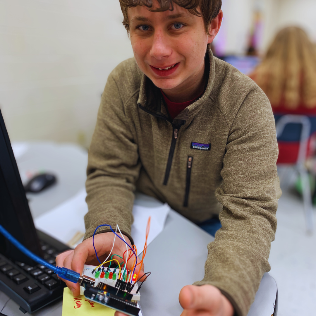 Kids building and coding a marble maze from a STEM project, exploring electronics and technology.