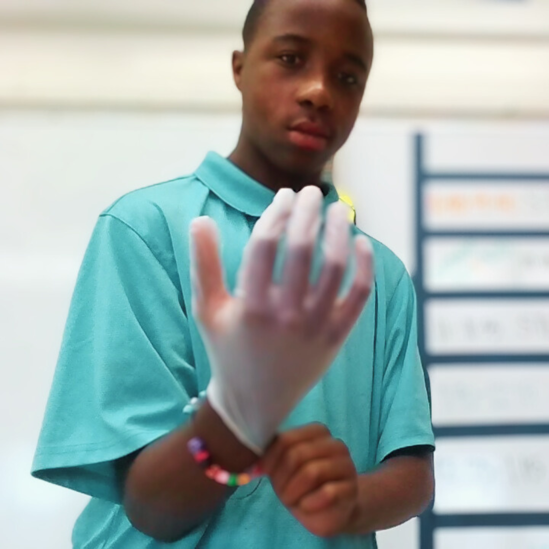 Kids practicing first aid techniques from a STEM kit, using real medical supplies.