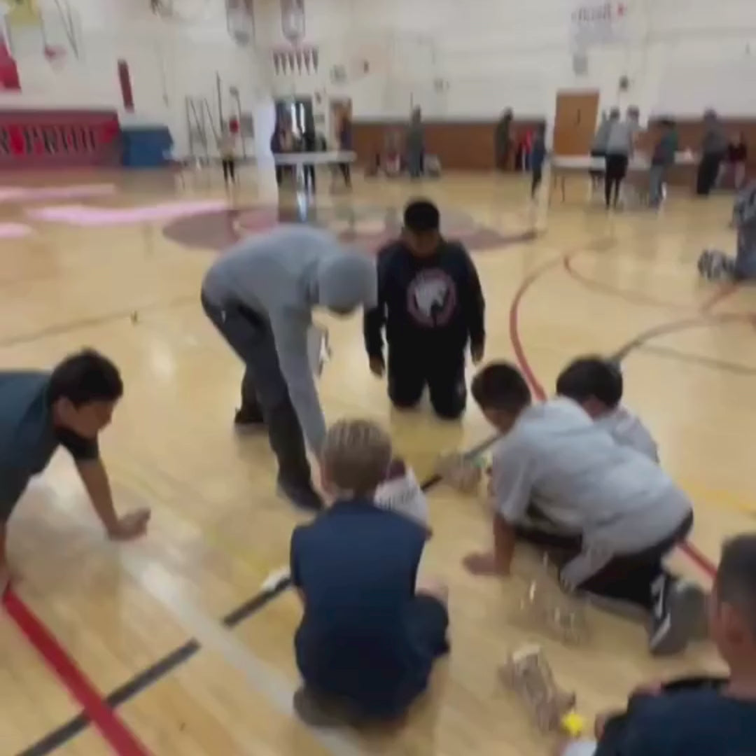 Kids build a catapult from a STEM project to explore engineering and physics concepts.