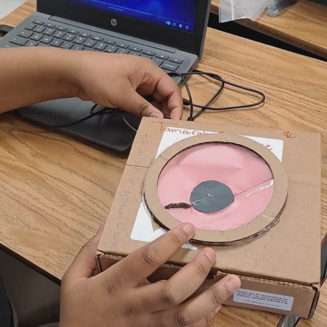 Kids assemble a speaker from a STEM project to learn how electrical energy creates sound.