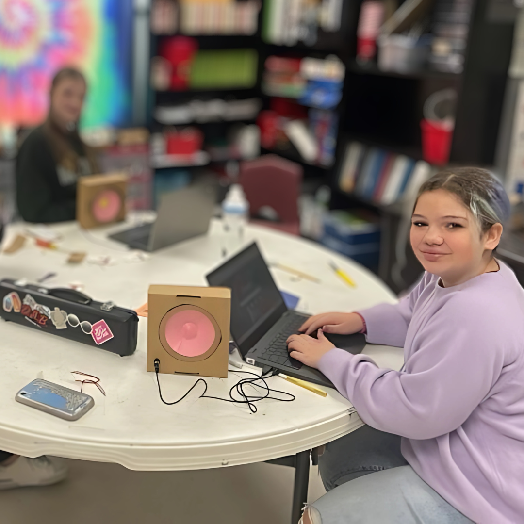 Kids assemble a speaker from a STEM kit to learn how electrical energy creates sound.