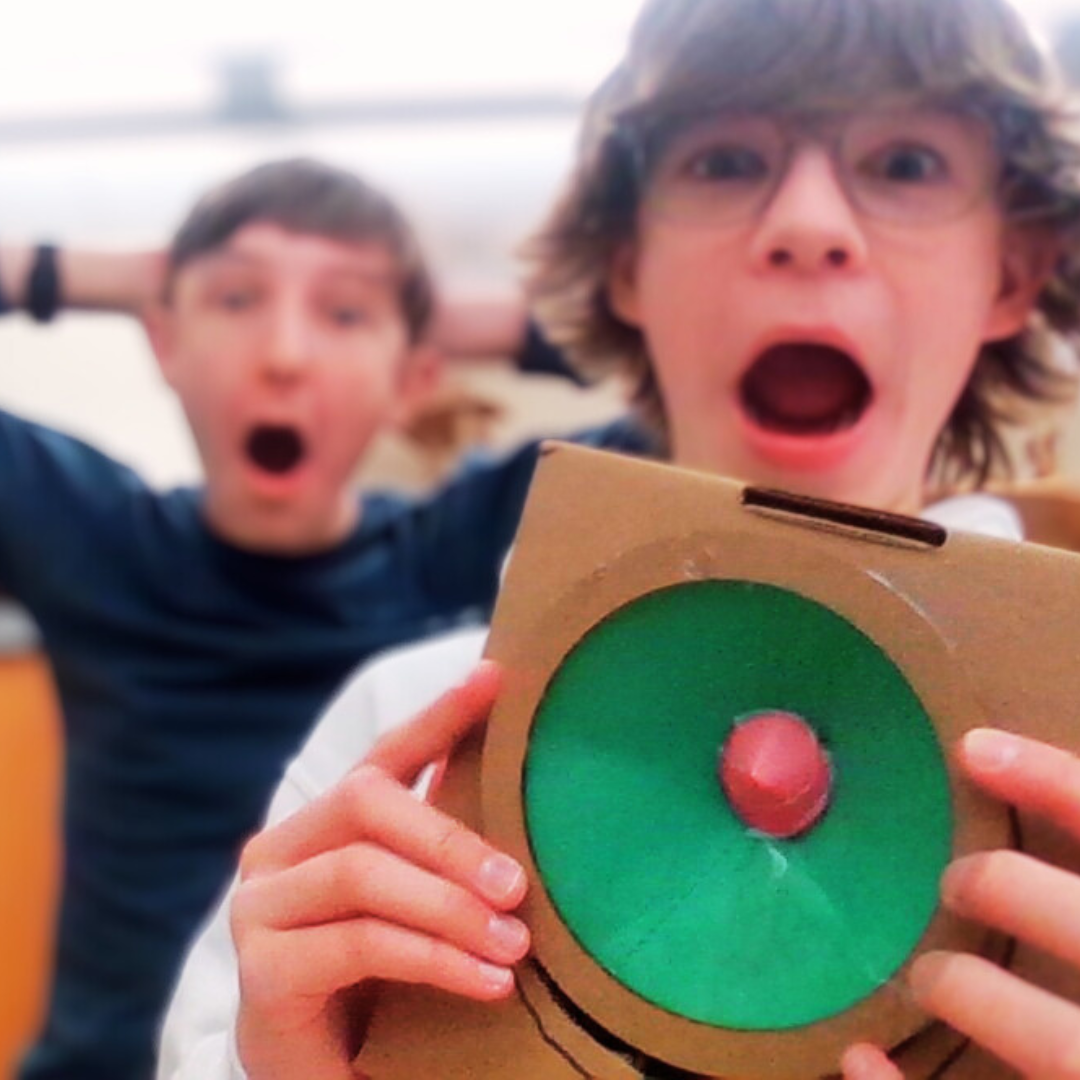 Kids assemble a speaker from a STEM project to learn how electrical energy creates sound.