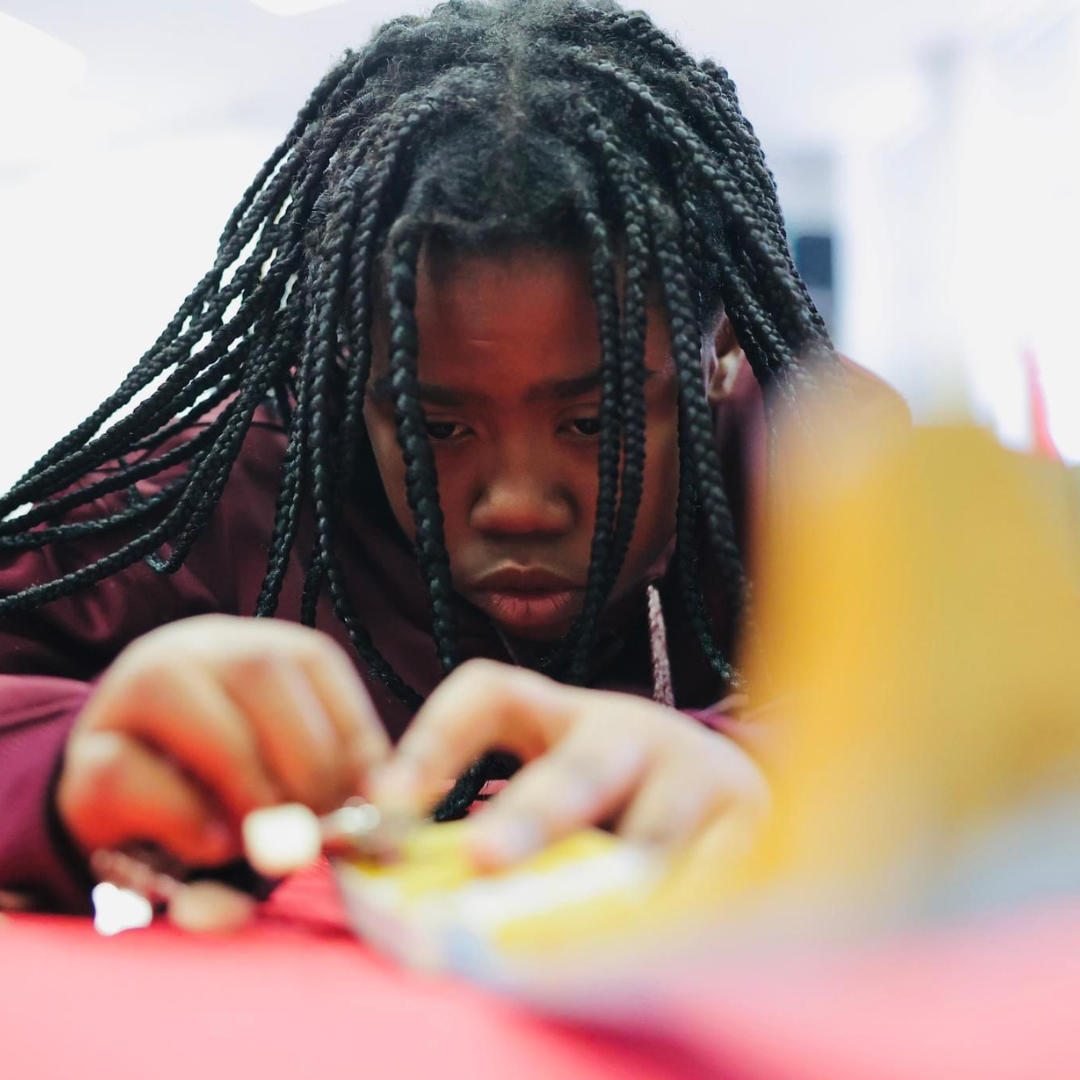 Kids assemble a ukulele from a STEM kit to explore the science of sound and music.