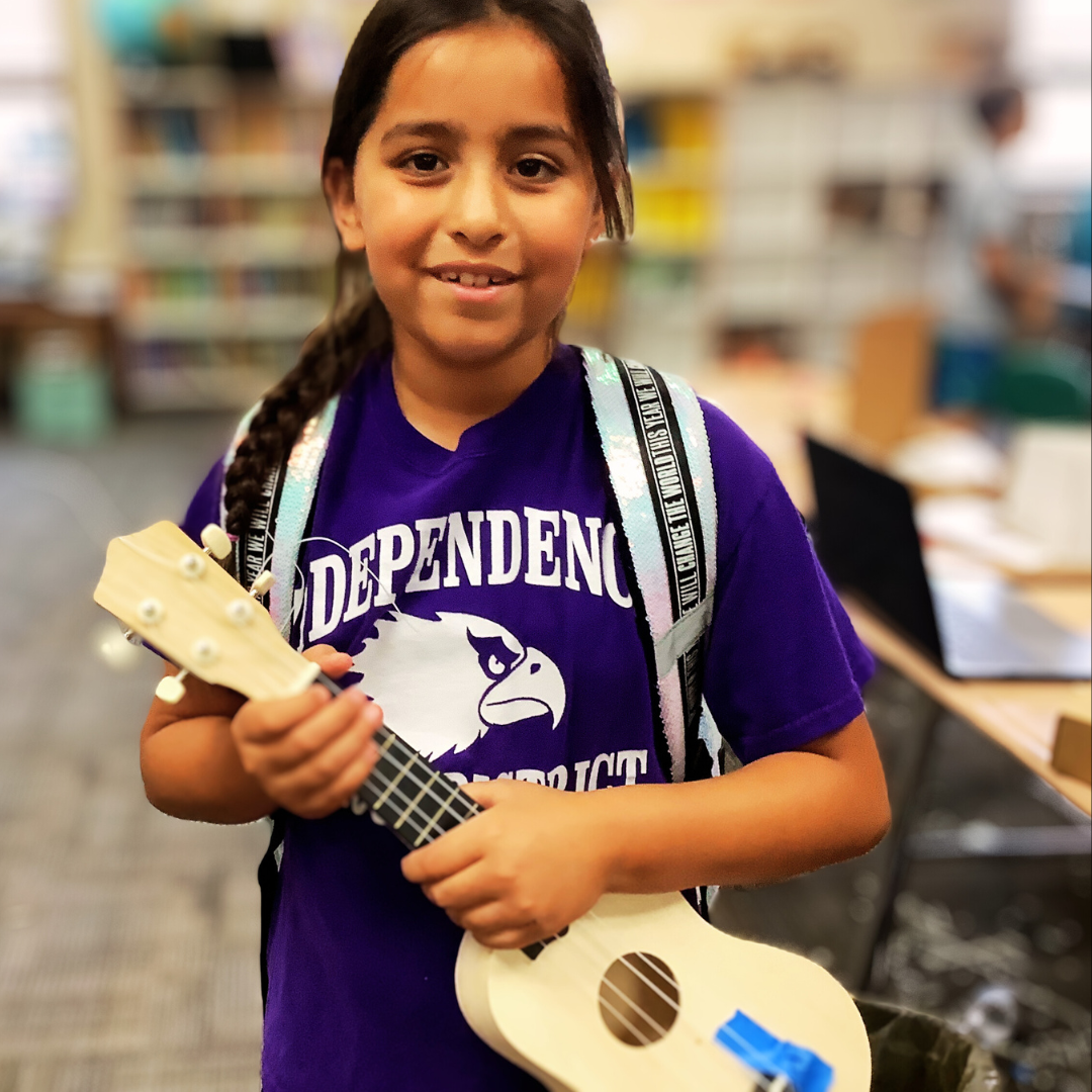 Kids assemble a ukulele from a STEM kit to explore the science of sound and music.