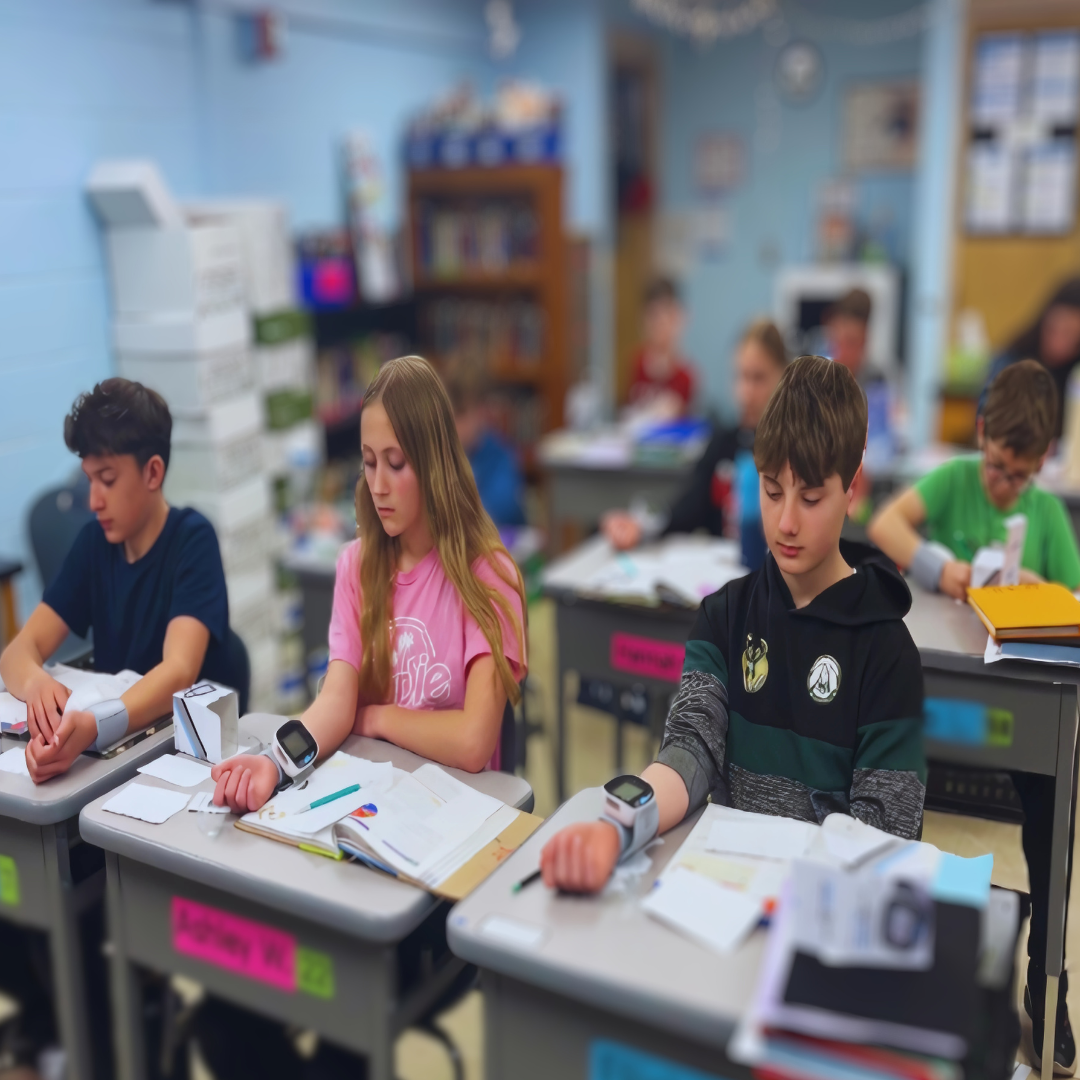 Kids use vital signs monitor from a STEM kit to learn about healthcare applications.